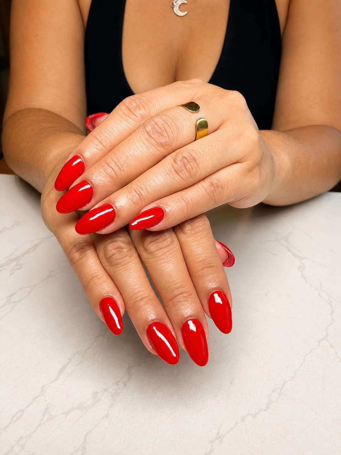 A close-up of two hands with a vivid magenta, square-tipped gel manicure, the kind of clean shape and finish a healthy Gel-X set holds for weeks.